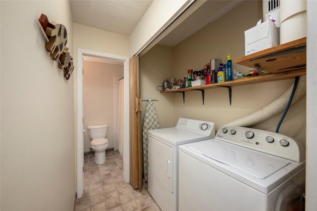 washroom with washing machine and clothes dryer and laundry area
