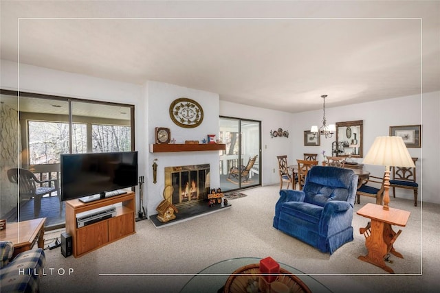 living room featuring carpet, a healthy amount of sunlight, and a glass covered fireplace