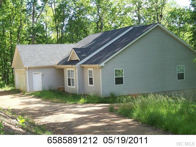 view of side of property with a garage