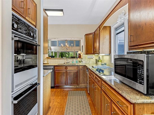 66 Country Club Vlg Unit 66, Lake Toxaway, NC 28747 - kitchen with appliances with stainless steel finishes, wood finished floors, healthy amount of natural light, and decorative backsplash