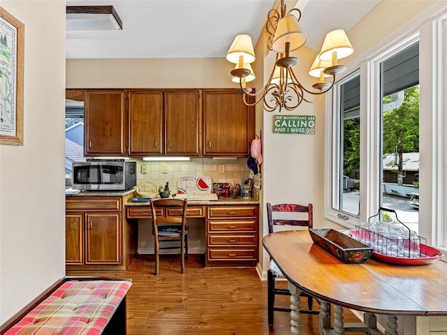 66 Country Club Vlg Unit 66, Lake Toxaway, NC 28747 - kitchen featuring stainless steel microwave, brown cabinets, decorative backsplash, and dark wood-style floors