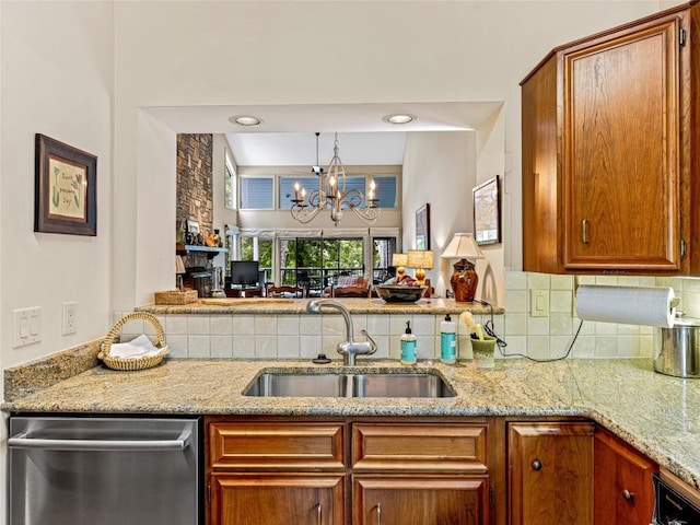 66 Country Club Vlg Unit 66, Lake Toxaway, NC 28747 - kitchen with dishwasher, a chandelier, decorative backsplash, light stone counters, and brown cabinetry