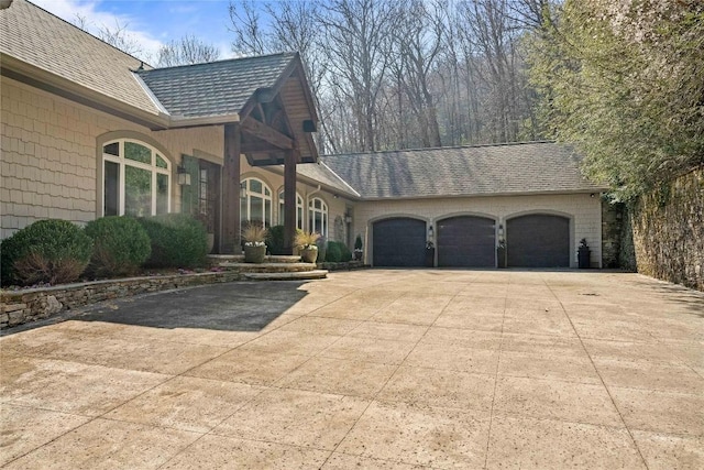 170 Old Hunters Run, Cashiers, NC 28717 - view of property exterior with concrete driveway, an attached garage, and roof with shingles