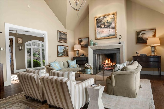 170 Old Hunters Run, Cashiers, NC 28717 - living area featuring dark wood-style flooring, a warm lit fireplace, and high vaulted ceiling