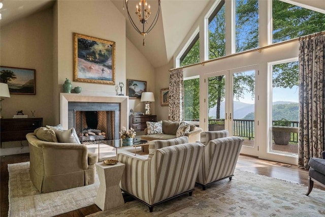 170 Old Hunters Run, Cashiers, NC 28717 - living area with a mountain view, wood finished floors, a chandelier, a fireplace, and high vaulted ceiling