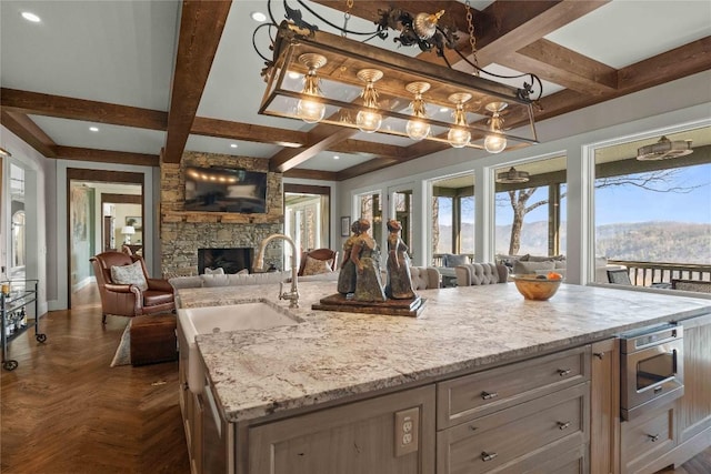 170 Old Hunters Run, Cashiers, NC 28717 - kitchen featuring open floor plan, stainless steel microwave, plenty of natural light, beam ceiling, and coffered ceiling