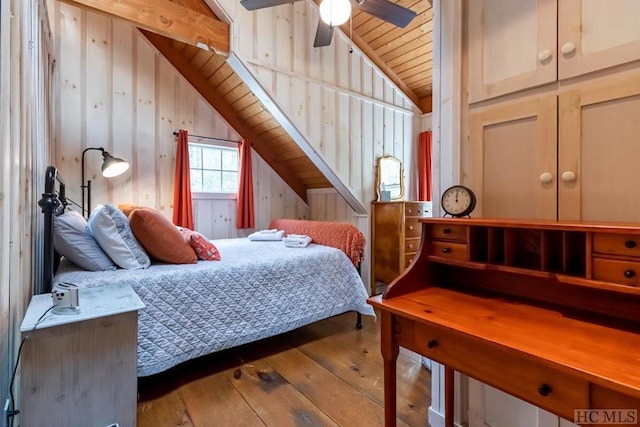 bedroom with wooden ceiling, wood-type flooring, ceiling fan, wood walls, and lofted ceiling