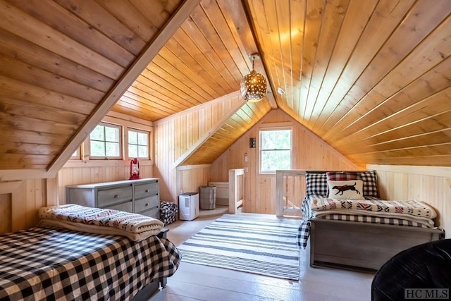 bedroom featuring wood walls, multiple windows, and vaulted ceiling