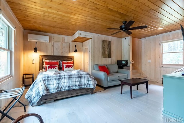 bedroom with light hardwood / wood-style flooring, a wall mounted AC, wood ceiling, and wooden walls