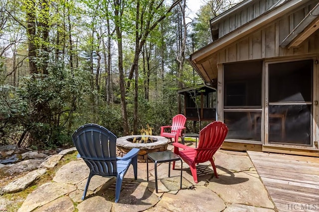 view of patio with a wooden deck and a fire pit