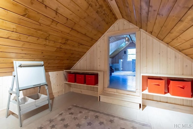 additional living space featuring wood walls, lofted ceiling, and wood ceiling