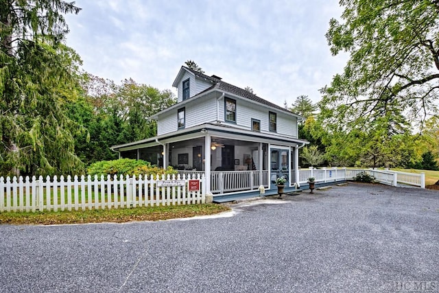 farmhouse-style home with a sunroom