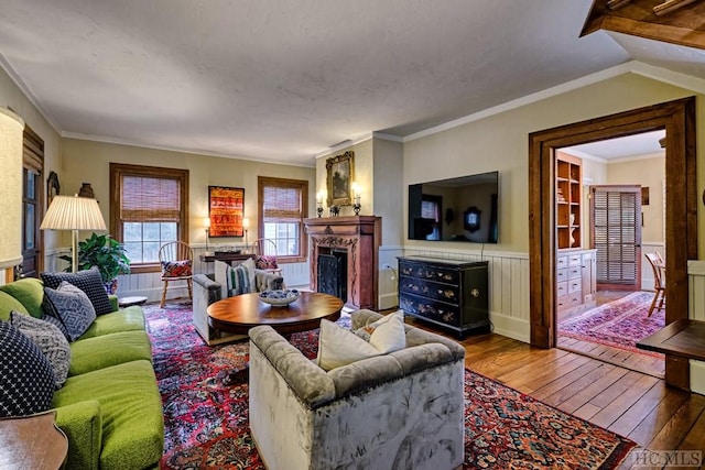 living room with crown molding and hardwood / wood-style floors