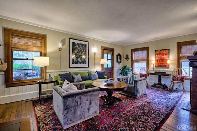 living room with hardwood / wood-style flooring and crown molding