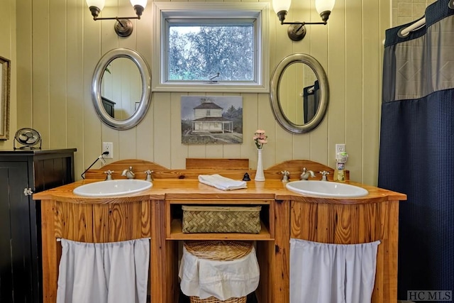 bathroom with vanity and wooden walls