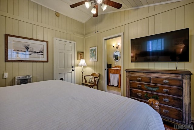 bedroom with lofted ceiling, a wall unit AC, and ceiling fan