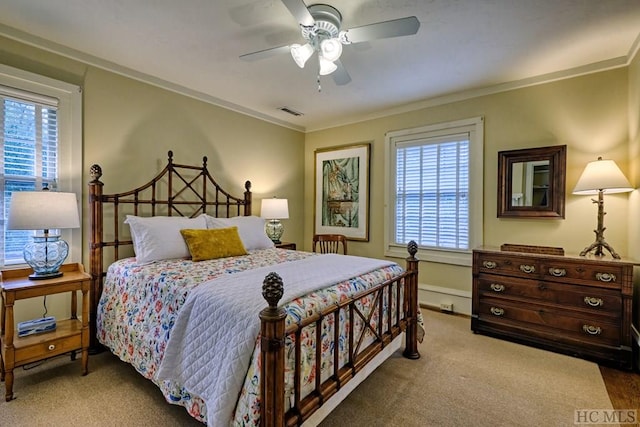 carpeted bedroom with crown molding and ceiling fan