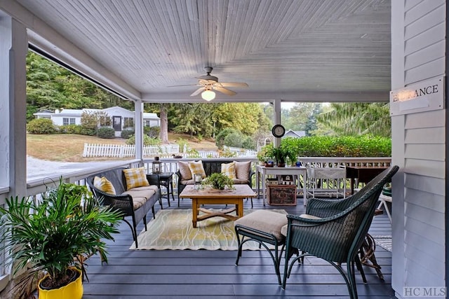 wooden deck featuring outdoor lounge area and ceiling fan