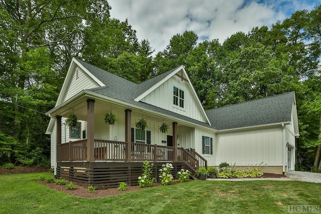 view of front of property with covered porch and a front lawn