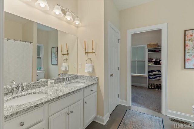 bathroom with vanity and toilet