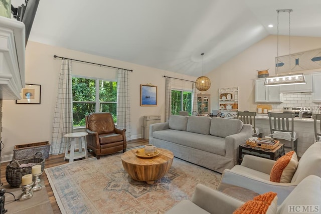 living room featuring lofted ceiling and light wood-type flooring