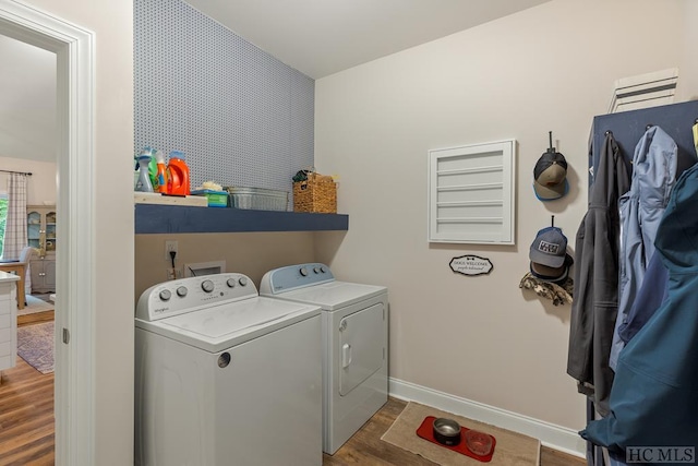 laundry area with dark hardwood / wood-style floors and independent washer and dryer