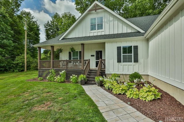 view of front of home with covered porch and a front lawn