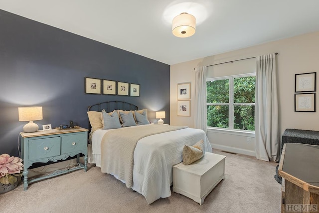 bedroom featuring light carpet