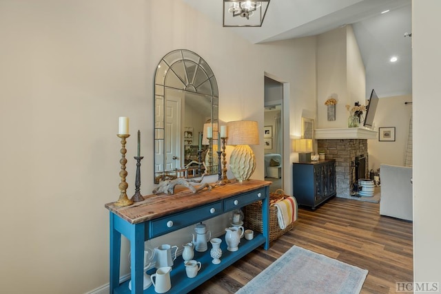 interior space featuring dark wood-type flooring, blue cabinets, wooden counters, high vaulted ceiling, and a fireplace