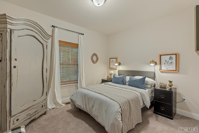 bedroom featuring light carpet