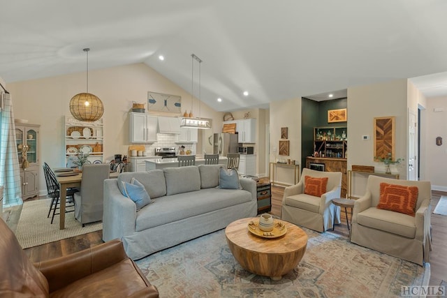 living room featuring vaulted ceiling and light wood-type flooring