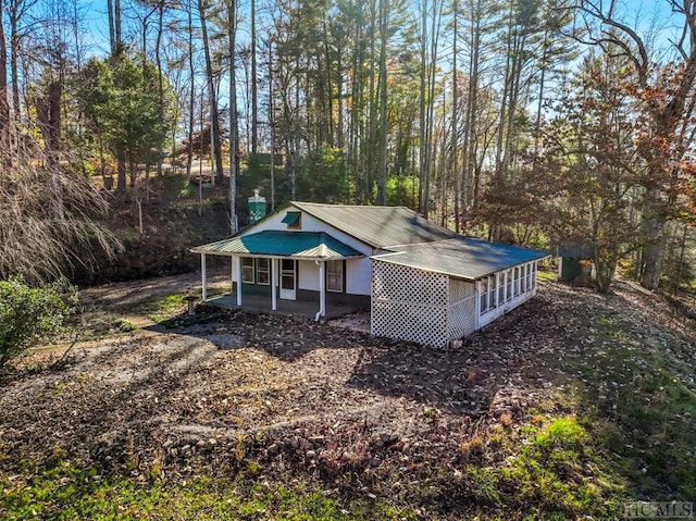 back of property with covered porch