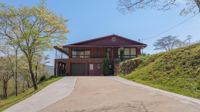 380 Ledford Dr, Franklin, NC 28734 - rustic home featuring a garage, brick siding, and concrete driveway