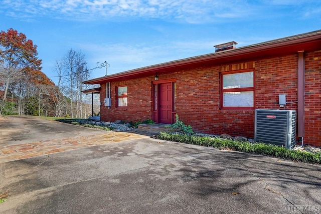 ranch-style house with central AC unit