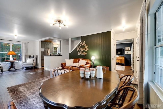 dining area with crown molding and wood-type flooring