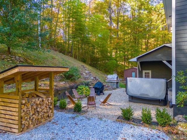 view of yard with an outdoor fire pit and a storage unit