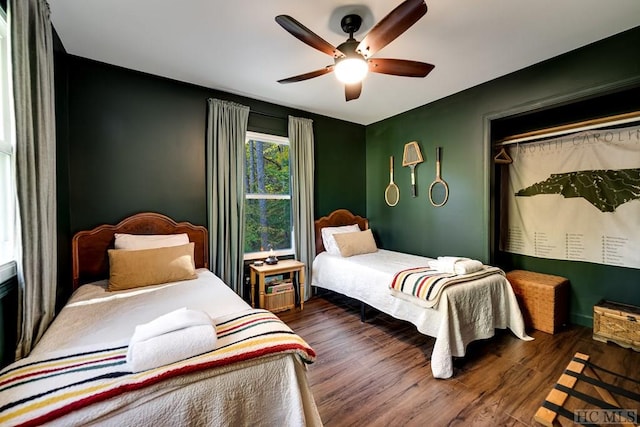 bedroom featuring dark wood-type flooring and ceiling fan