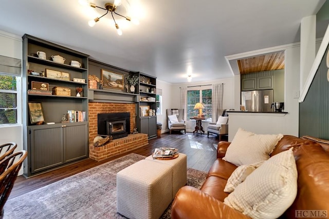 living room with a fireplace, ornamental molding, and dark hardwood / wood-style flooring