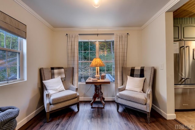 living area featuring hardwood / wood-style floors, crown molding, and a wealth of natural light