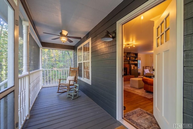 sunroom featuring ceiling fan