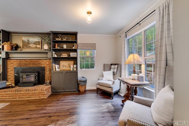 living area featuring crown molding, dark hardwood / wood-style flooring, and a wood stove