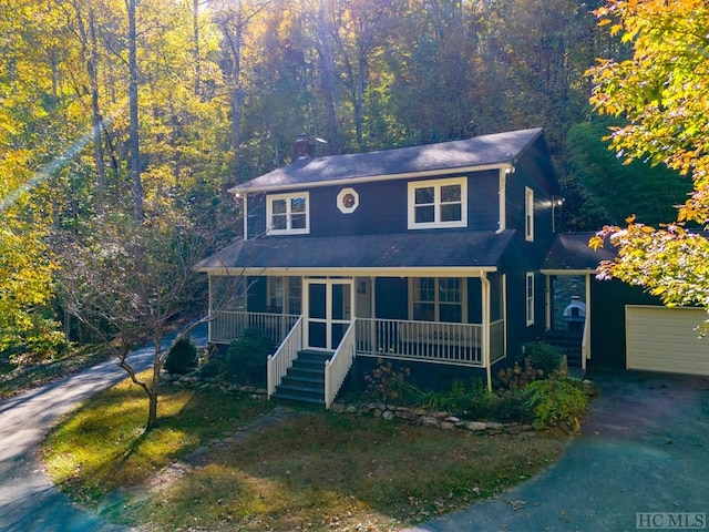 view of front facade featuring a porch and a garage