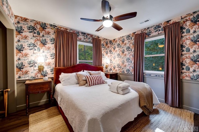 bedroom with ceiling fan and dark hardwood / wood-style floors