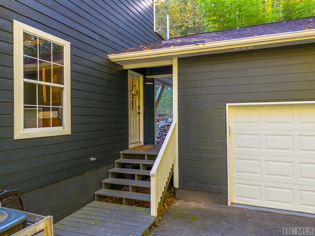 doorway to property with a garage