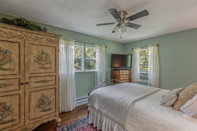 70 Rolling Acres Dr, Highlands, NC 28741 - bedroom featuring multiple windows, wood finished floors, a baseboard heating unit, and ceiling fan