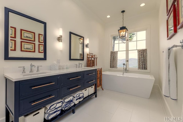 bathroom featuring vanity, tile patterned flooring, a bathtub, and a notable chandelier