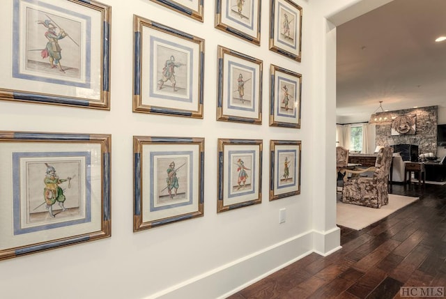 interior details with hardwood / wood-style floors and a stone fireplace