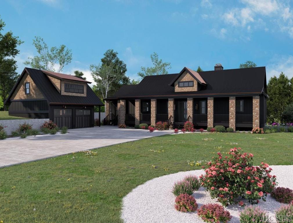 view of front of house featuring an outbuilding, a garage, driveway, and a front lawn