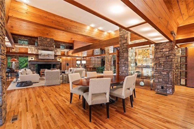 749 Stillmont Cir, Cashiers, NC 28717 - dining space featuring a fireplace, decorative columns, visible vents, and wood finished floors