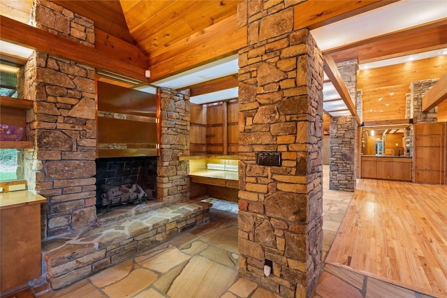 749 Stillmont Cir, Cashiers, NC 28717 - bathroom featuring wood walls, wood finished floors, decorative columns, a fireplace, and wood ceiling